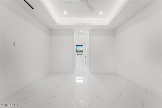 1220 Edward Ave, Lehigh Acres, FL 33972 - unfurnished room featuring marble finish floors, a tray ceiling, recessed lighting, and ceiling fan