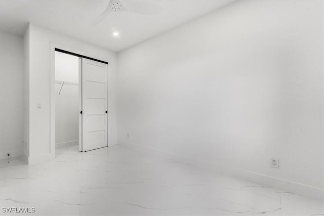1220 Edward Ave, Lehigh Acres, FL 33972 - unfurnished bedroom featuring light marble finish floors, a closet, and a ceiling fan