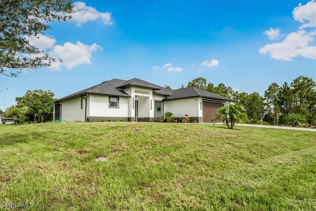 1220 Edward Ave, Lehigh Acres, FL 33972 - prairie-style house featuring stucco siding and a front lawn