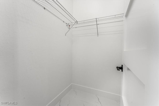 1220 Edward Ave, Lehigh Acres, FL 33972 - walk in closet featuring marble look tile flooring