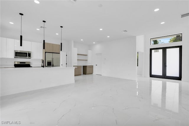 3202 21st St W, Lehigh Acres, FL 33971 - unfurnished living room with recessed lighting, light marble finish floors, french doors, and a high ceiling