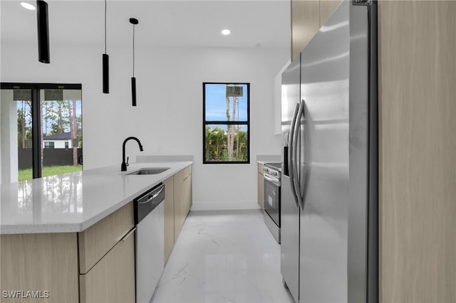 3202 21st St W, Lehigh Acres, FL 33971 - kitchen with appliances with stainless steel finishes, modern cabinets, light marble finish flooring, healthy amount of natural light, and recessed lighting