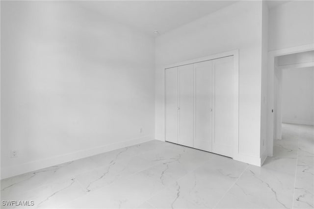 3202 21st St W, Lehigh Acres, FL 33971 - unfurnished bedroom with marble finish flooring and a closet
