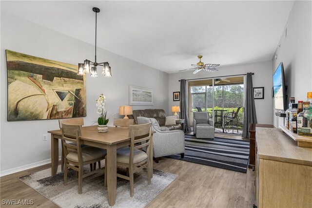 3760 Sawgrass Way Unit 3514, Naples, FL 34112 - dining space with light wood finished floors, ceiling fan, and a chandelier