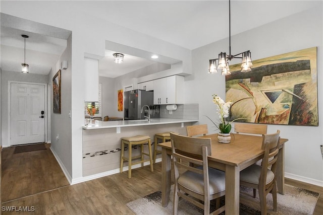 3760 Sawgrass Way Unit 3514, Naples, FL 34112 - dining room with dark wood-style floors and a chandelier