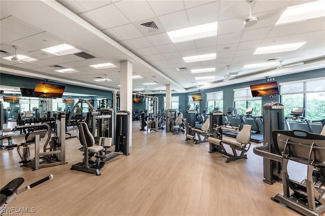 3760 Sawgrass Way Unit 3514, Naples, FL 34112 - exercise room featuring a drop ceiling and wood finished floors