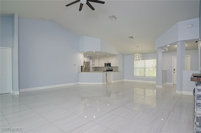 601 Clayton Ave, Lehigh Acres, FL 33972 - unfurnished living room featuring a ceiling fan, light tile patterned floors, a chandelier, and high vaulted ceiling