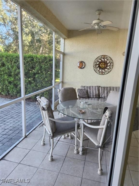 1240 Shady Rest Ln Unit 104, Naples, FL 34103 - sunroom featuring ceiling fan and outdoor dining area