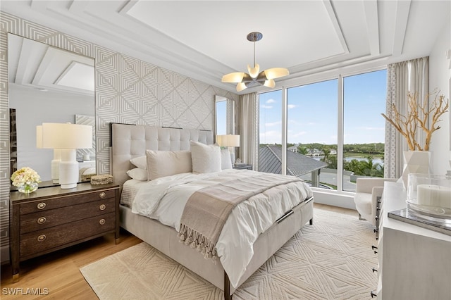 13925 Old Coast Rd Unit 403, Naples, FL 34110 - bedroom with a chandelier, light wood finished floors, access to exterior, and a water view