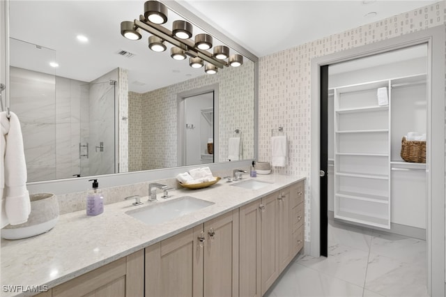 13925 Old Coast Rd Unit 403, Naples, FL 34110 - bathroom with a stall shower, double vanity, a walk in closet, and marble look tiles