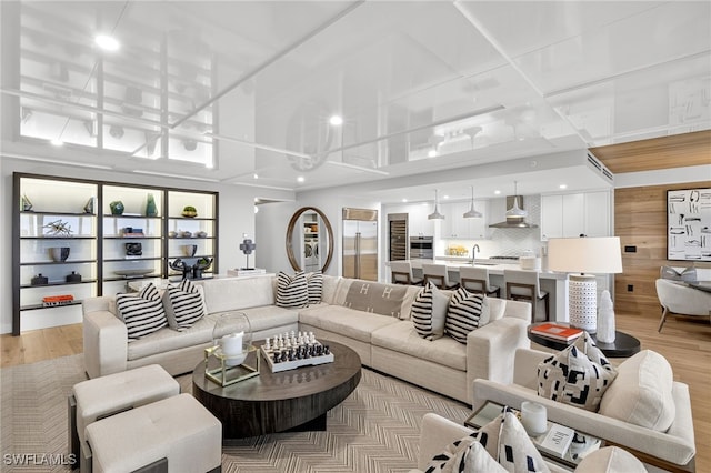 13925 Old Coast Rd Unit 403, Naples, FL 34110 - living room with recessed lighting and light wood-style floors
