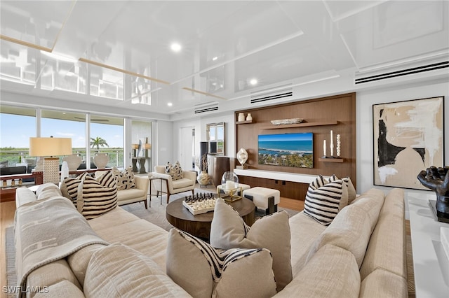 13925 Old Coast Rd Unit 403, Naples, FL 34110 - living area featuring a wall unit AC, recessed lighting, and wood finished floors