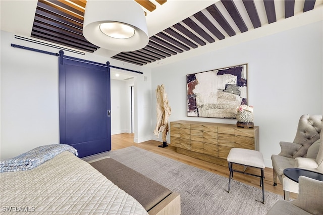 13925 Old Coast Rd Unit 403, Naples, FL 34110 - bedroom with a barn door and wood finished floors