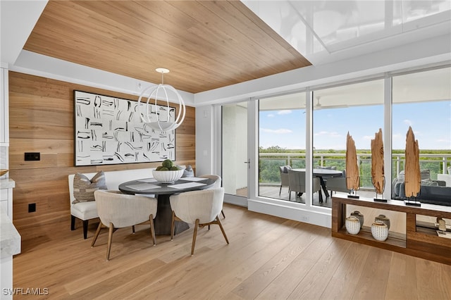 13925 Old Coast Rd Unit 403, Naples, FL 34110 - dining space with plenty of natural light, a chandelier, wood ceiling, and wood finished floors