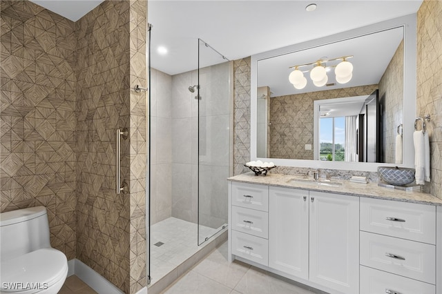13925 Old Coast Rd Unit 403, Naples, FL 34110 - bathroom featuring tile patterned flooring, vanity, a shower stall, and tile walls