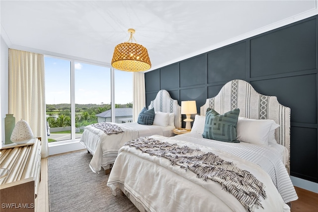 13925 Old Coast Rd Unit 403, Naples, FL 34110 - bedroom with a decorative wall, wood finished floors, and floor to ceiling windows