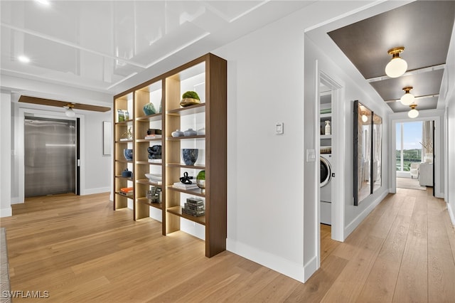 13925 Old Coast Rd Unit 403, Naples, FL 34110 - hallway featuring light wood finished floors and washer / dryer
