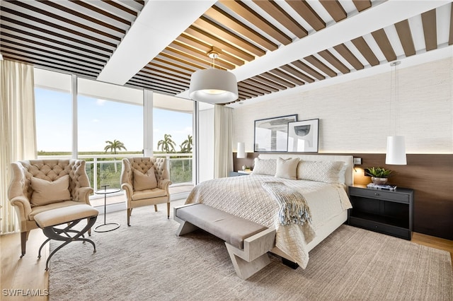 13925 Old Coast Rd Unit 403, Naples, FL 34110 - bedroom with expansive windows and wood finished floors