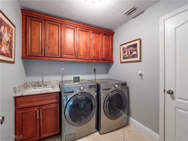 1431 SW 53rd Ln, Cape Coral, FL 33914 - washroom featuring cabinet space, separate washer and dryer, light tile patterned flooring, and a textured ceiling