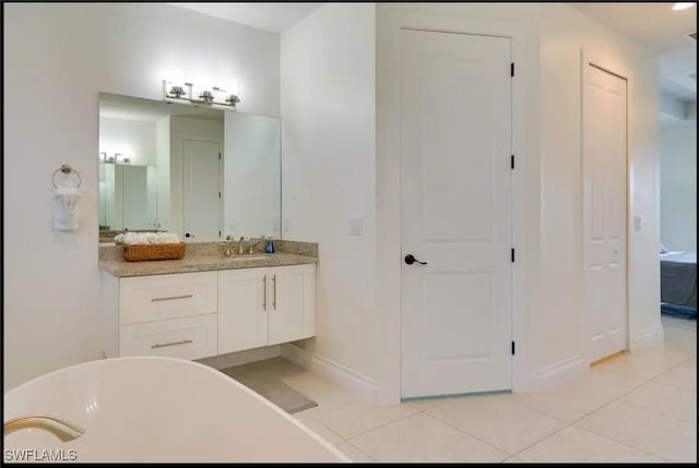 2229 SW 17th Pl, Cape Coral, FL 33991 - full bath with a freestanding tub, vanity, tile patterned floors, and a closet
