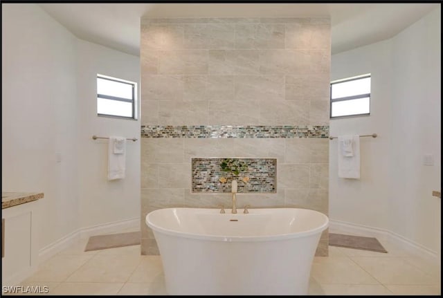 2229 SW 17th Pl, Cape Coral, FL 33991 - bathroom with a soaking tub, tile patterned floors, and plenty of natural light