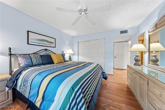 519 Seaview Ct Unit N4, Marco Island, FL 34145 - bedroom with a closet, light wood-type flooring, a textured ceiling, and ceiling fan