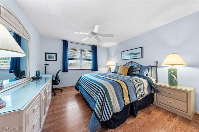 519 Seaview Ct Unit N4, Marco Island, FL 34145 - bedroom featuring light wood finished floors, a textured ceiling, a desk, and a ceiling fan