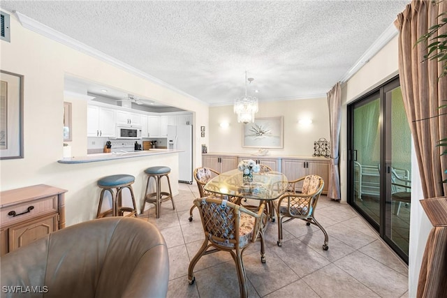 519 Seaview Ct Unit N4, Marco Island, FL 34145 - dining area with crown molding, a textured ceiling, light tile patterned floors, and a chandelier