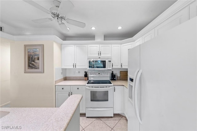519 Seaview Ct Unit N4, Marco Island, FL 34145 - kitchen featuring white appliances, light countertops, light tile patterned floors, white cabinetry, and recessed lighting