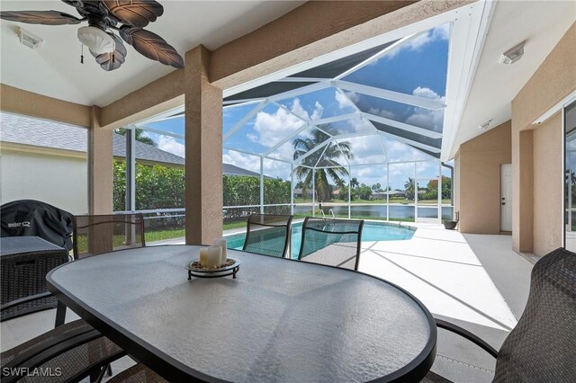 1962 Terrazzo Ln, Naples, FL 34104 - swimming pool with outdoor dining area, a ceiling fan, a patio, and glass enclosure