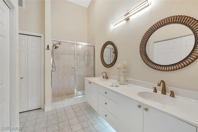 6720 Beach Resort Dr Unit 10, Naples, FL 34114 - bathroom featuring a closet, a shower stall, double vanity, and tile patterned flooring