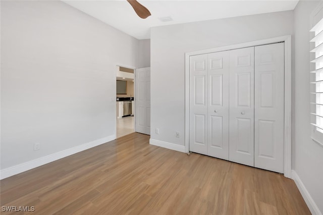 6720 Beach Resort Dr Unit 10, Naples, FL 34114 - unfurnished bedroom with light wood finished floors, a closet, and a ceiling fan