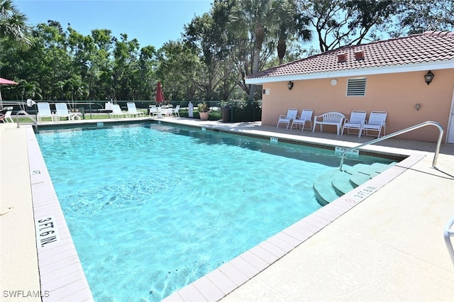 6720 Beach Resort Dr Unit 10, Naples, FL 34114 - community pool featuring a patio and view of scattered trees