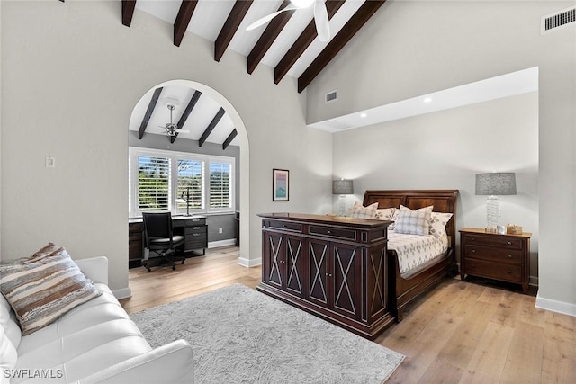 5850 Pelican Bay Blvd Unit C, Naples, FL 34108 - bedroom with arched walkways, a desk, and light wood-type flooring