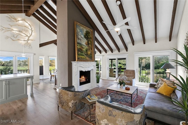 5850 Pelican Bay Blvd Unit C, Naples, FL 34108 - living area with a fireplace with flush hearth, light wood finished floors, and healthy amount of natural light