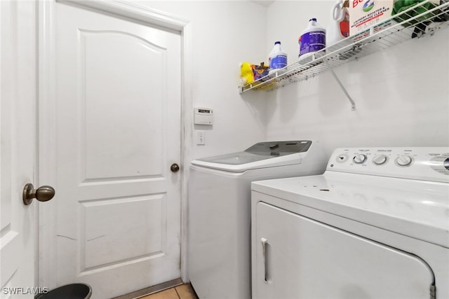1439 SW Embers Ter, Cape Coral, FL 33991 - washroom with washing machine and clothes dryer and light tile patterned flooring