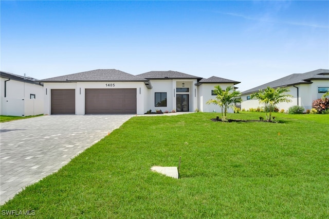 1405 SW 28th Ter, Cape Coral, FL 33914 - prairie-style home featuring an attached garage, decorative driveway, a front lawn, and stucco siding