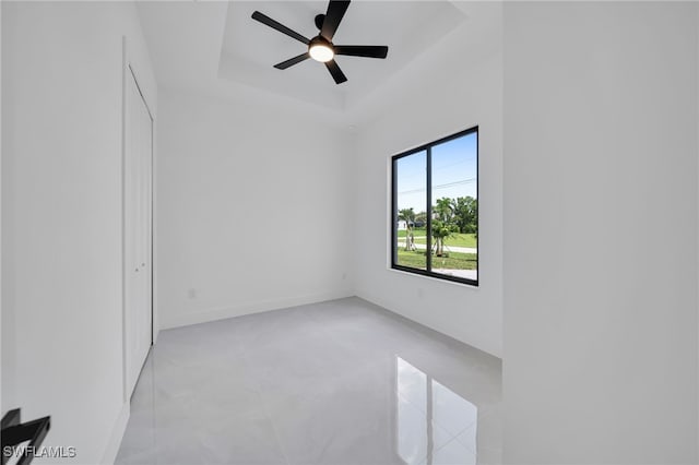 1405 SW 28th Ter, Cape Coral, FL 33914 - spare room with a tray ceiling and ceiling fan