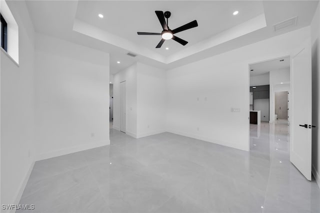 1405 SW 28th Ter, Cape Coral, FL 33914 - empty room featuring a tray ceiling, a ceiling fan, and recessed lighting