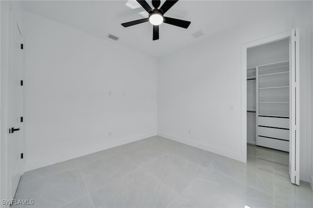 1405 SW 28th Ter, Cape Coral, FL 33914 - unfurnished bedroom with a walk in closet, a closet, and a ceiling fan