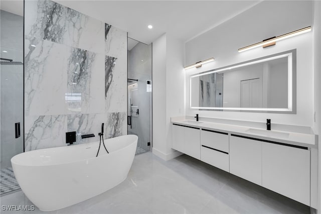 1405 SW 28th Ter, Cape Coral, FL 33914 - bathroom with a stall shower, double vanity, a freestanding tub, marble tiled flooring, and tile walls
