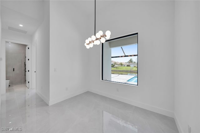 1405 SW 28th Ter, Cape Coral, FL 33914 - empty room with baseboards and a chandelier