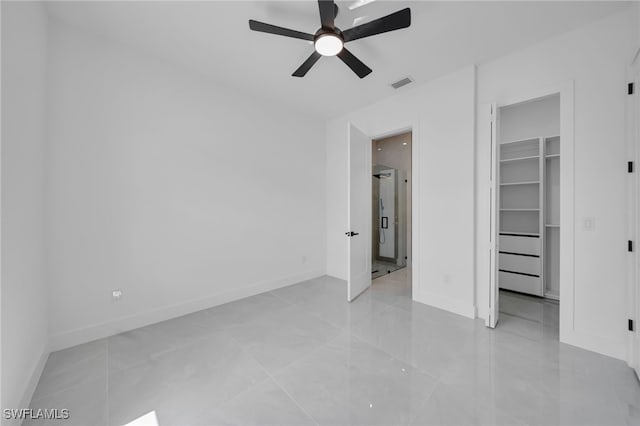 1405 SW 28th Ter, Cape Coral, FL 33914 - unfurnished bedroom featuring a spacious closet, ceiling fan, a closet, and light tile patterned floors