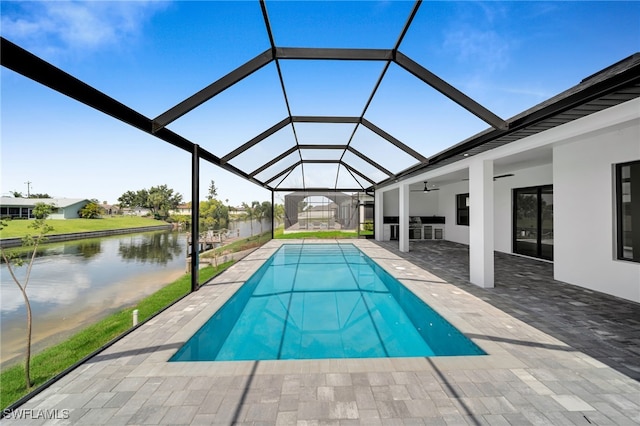 1405 SW 28th Ter, Cape Coral, FL 33914 - swimming pool with a ceiling fan, a patio, a water view, and glass enclosure