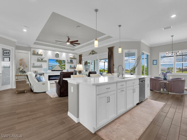 15904 Talon Ter, Punta Gorda, FL 33982 - kitchen featuring stainless steel dishwasher, wood finished floors, white cabinets, a ceiling fan, and ornamental molding