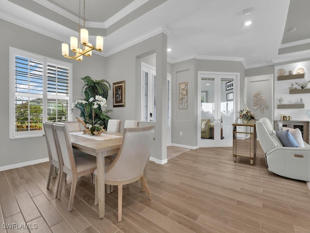 15904 Talon Ter, Punta Gorda, FL 33982 - dining space with a chandelier, light wood-type flooring, a raised ceiling, french doors, and recessed lighting