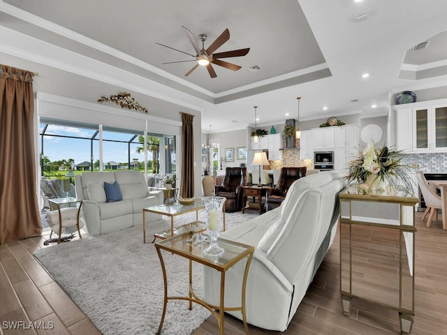 15904 Talon Ter, Punta Gorda, FL 33982 - living area with a ceiling fan, a raised ceiling, wood finished floors, ornamental molding, and recessed lighting