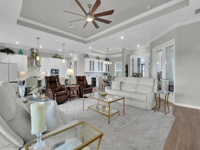 15904 Talon Ter, Punta Gorda, FL 33982 - living area featuring a raised ceiling, ceiling fan, light wood-type flooring, wine cooler, and recessed lighting