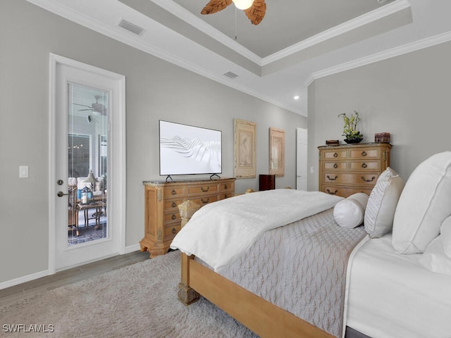 15904 Talon Ter, Punta Gorda, FL 33982 - bedroom with wood finished floors, crown molding, a tray ceiling, a ceiling fan, and recessed lighting