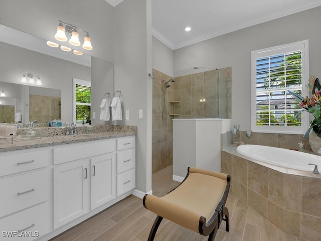 15904 Talon Ter, Punta Gorda, FL 33982 - bathroom featuring a walk in shower, vanity, a garden tub, ornamental molding, and wood finished floors